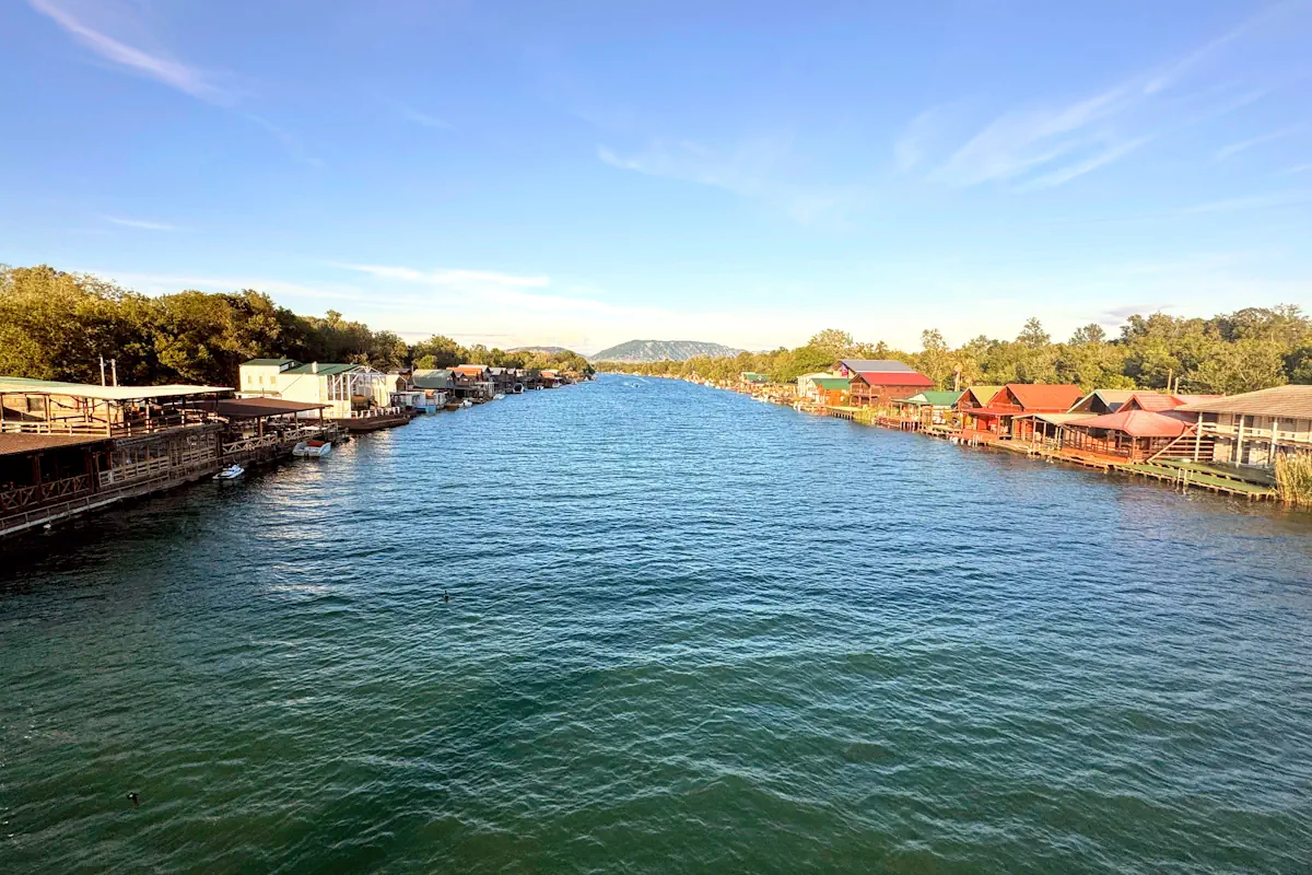 Bojana River with wooden stilt houses separating the island from Long Beach, Montenegro