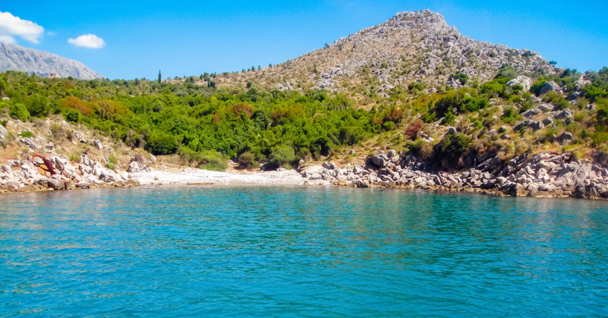 Wild Bigovica beach with limestone cliffs and Mediterranean shrubs