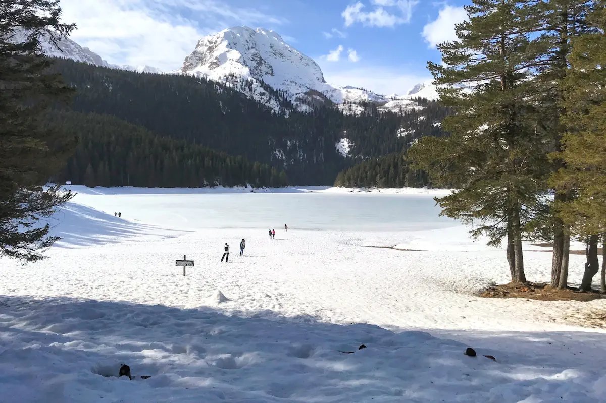 Black Lake Montenegro frozen in winter with snow-capped peaks