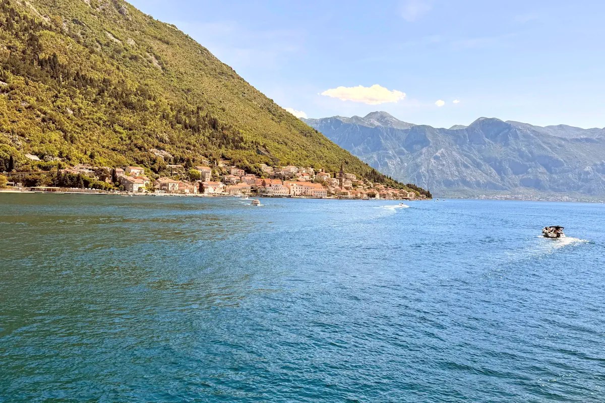 Speedboat cruising through Boka Bay Montenegro past Perast