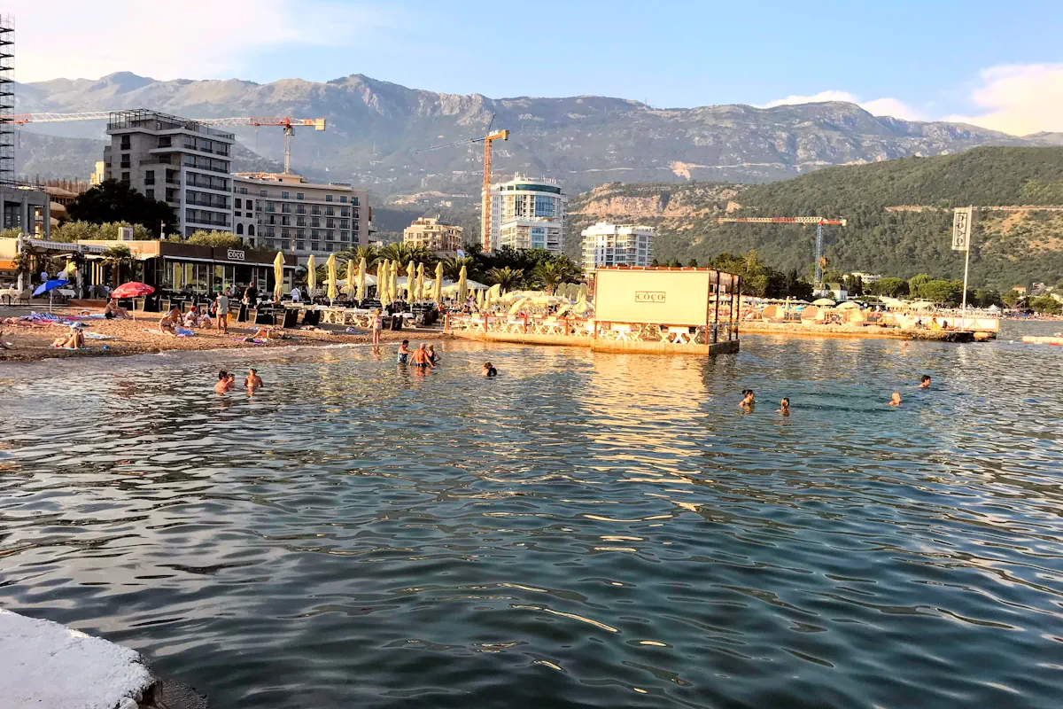 Budva Slovenska Beach backed by modern condo buildings and mountains