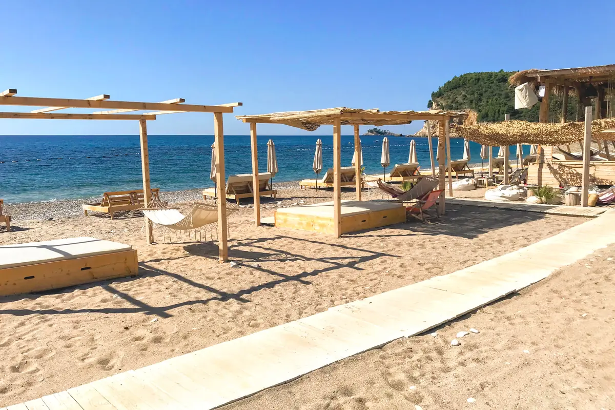 Boho-style sun loungers and cabanas on Buljarica Beach, near Petrovac