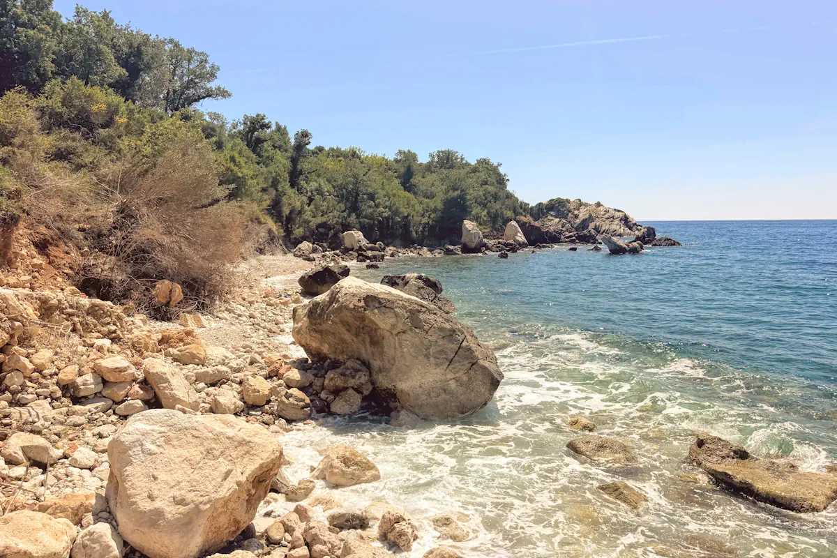 The dramatic red cliffs and turquoise water of the Crvena Glavica nudist bays