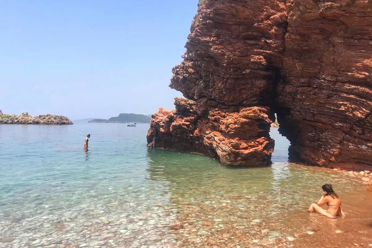 The dramatic sea arch and cliff jumping points at Crvena Stijena beach