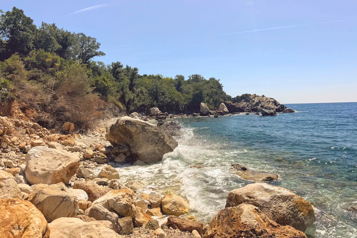 View of the nudist section at the southern ends of Crvena Stijena Beach, Sveti Stefan, Montenegro