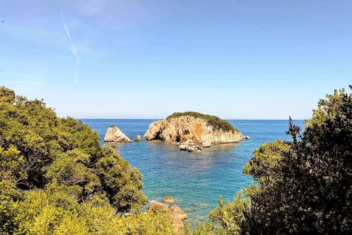 The Island of Stari Ulcinj surrounded by clear glass-like waters at Crystal Beach near Kruce