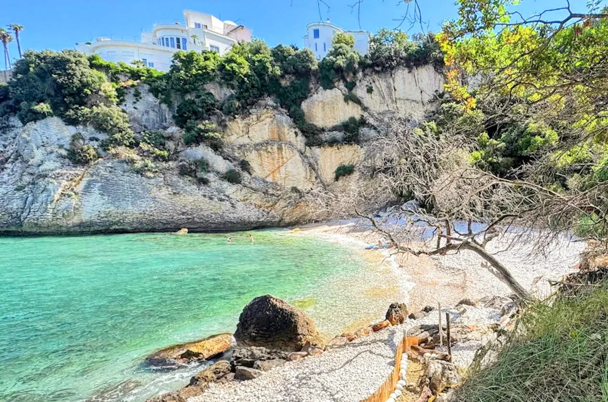 Panoramic view of Crystal Beach (Kristalna Plaza) showing turquoise waters and surrounding cliffs along the Ulcinj Riviera