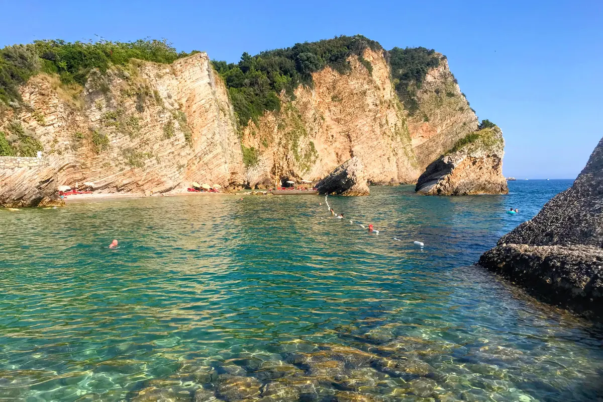 Halfmoon Beach on Sveti Nikola Island, a sickle-shaped rocky bay with crystalline shallows and towering cliffs
