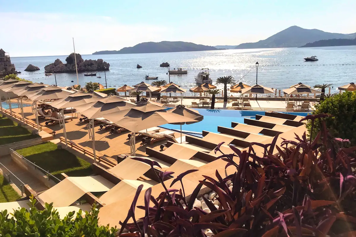 Prno Beach Hotel Maestral Pool during the day and parasols