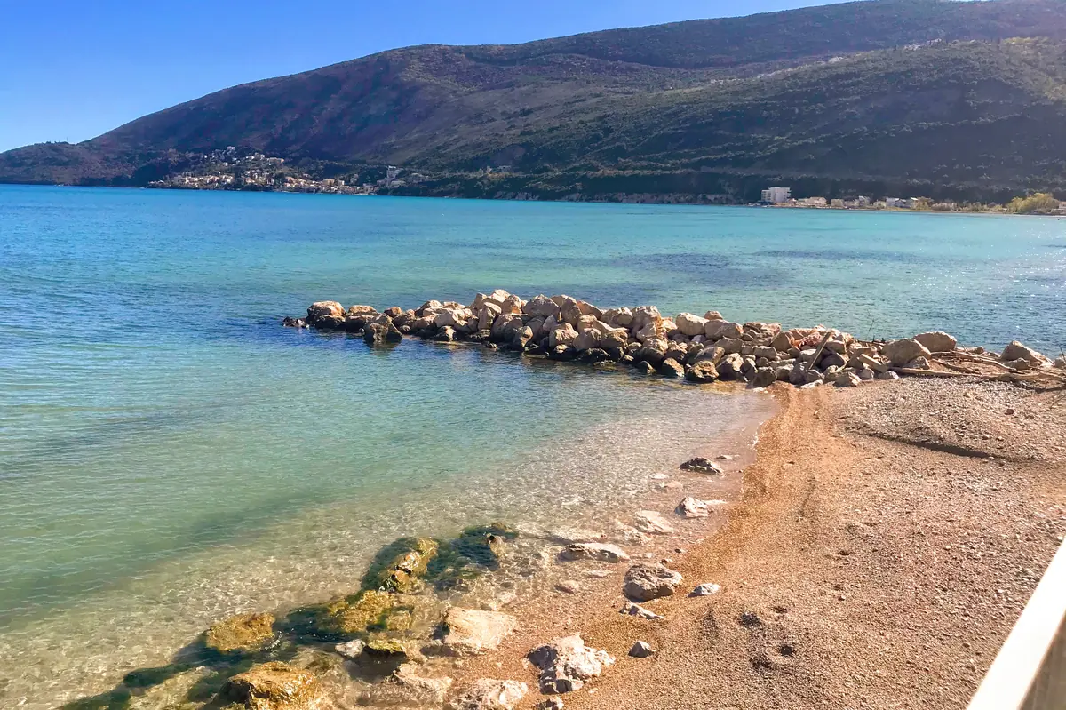 The sandy expanse of Igalo Mud Beach in Herceg Novi overlooking the Prevlaka Peninsula bordering Croatia