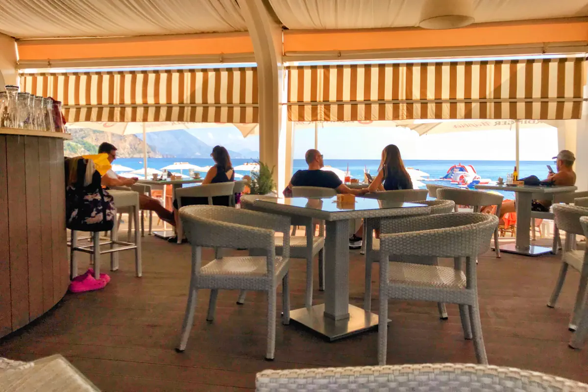 Beachside restaurants along the paved promenade of Jaz Beach offering fresh seafood dishes