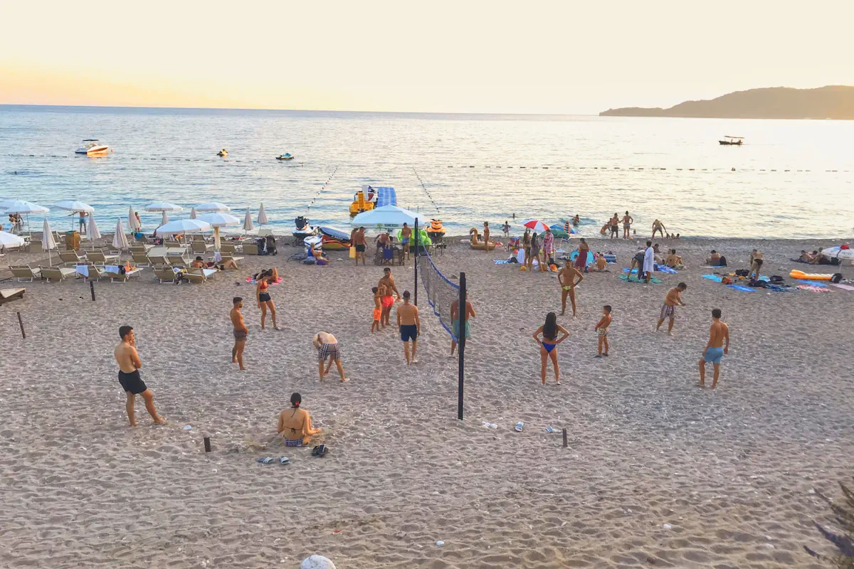 Beach volleyball and sunset at Kamenovo Beach, Budva