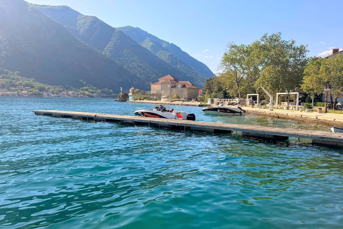Waterfront stone boarding piers along the Dobrota Promenade