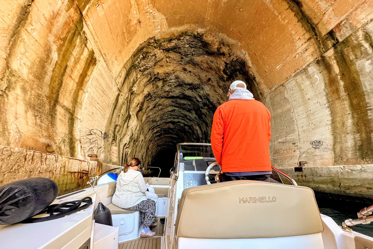 Speedboat steering directly inside a former Yugoslav naval submarine tunnel on the Lustica Peninsula