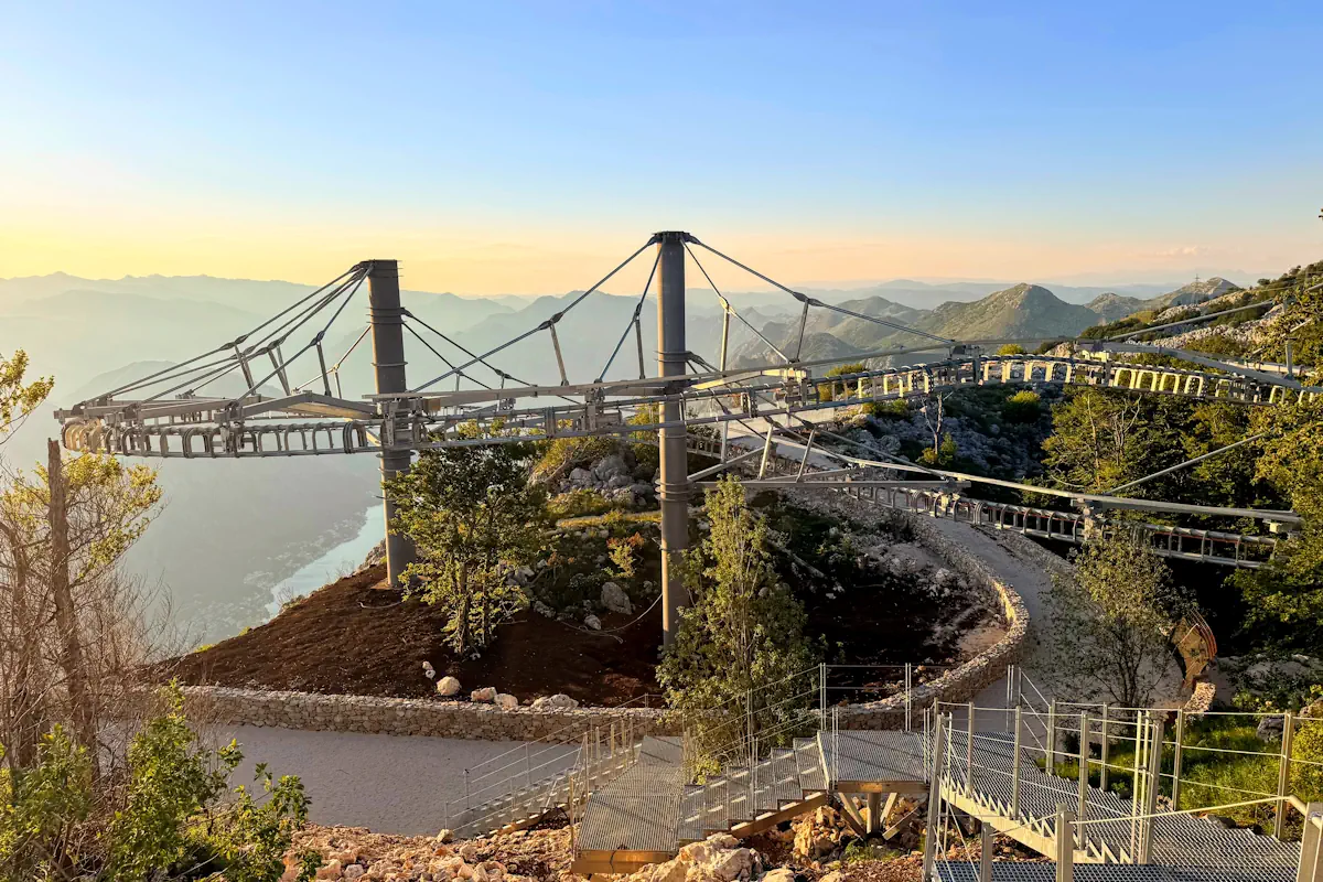 An aerial perspective of the gravity-driven alpine coaster Kuk Summit Station with Boka Bay in the background