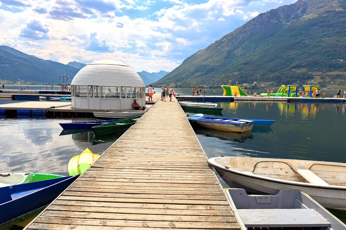 Lake Plav Pier with kayaks and boats and the inflatable playground