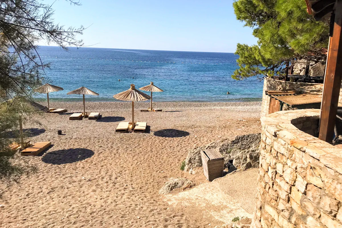 Beachside restaurants and pine trees at Lucice Beach