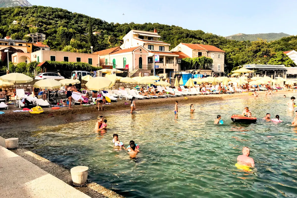 Meljine beach waterfront with children splashing in the shallows