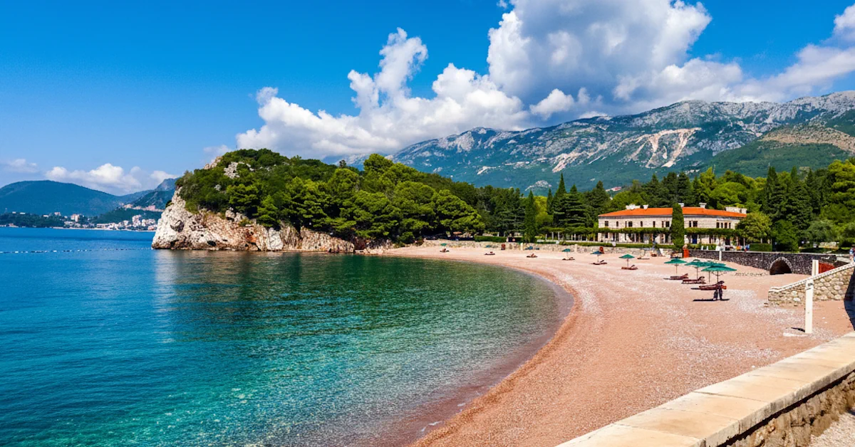 Milocer Beach near Sveti Stefan, showing the pink pebbles, clear water, and the historic stone summer residence