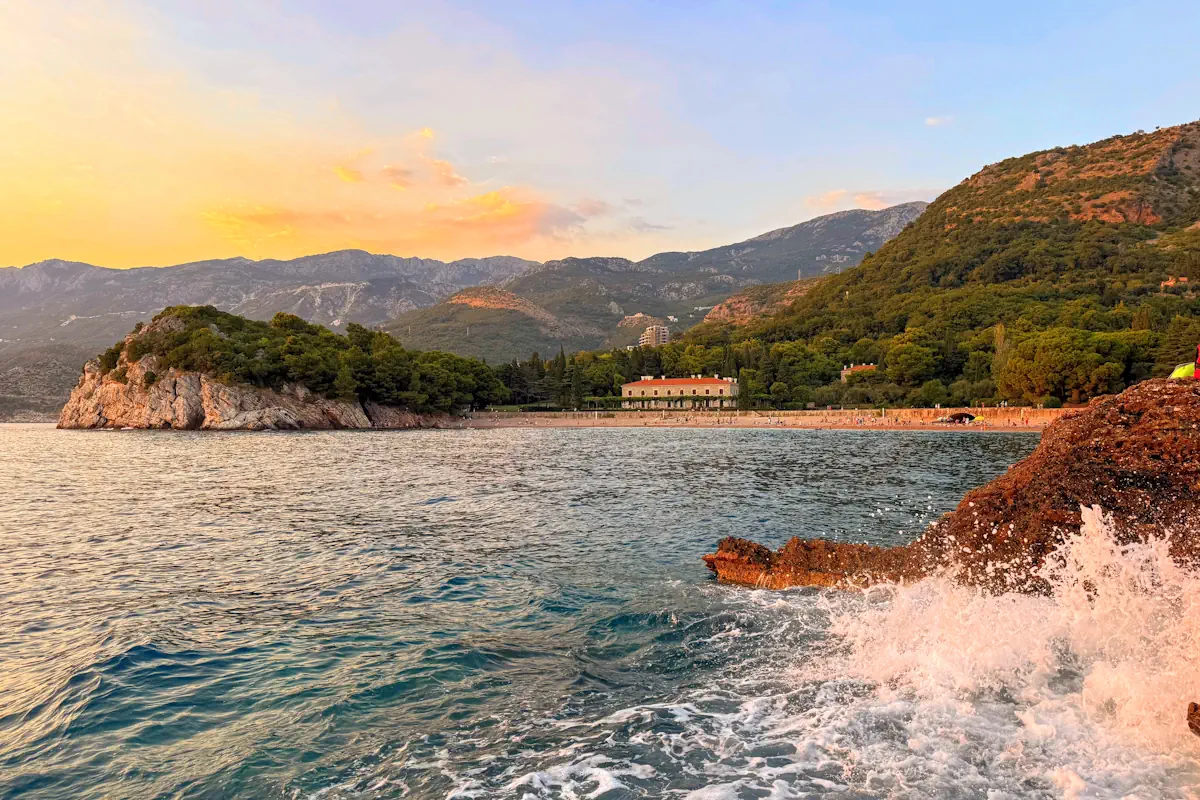 The elegant waterfront of Milocer Beach surrounded by the lush royal park