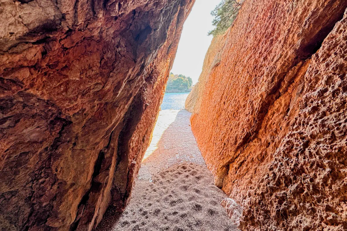 The passage emerging from the limestone cliffside passage at Miločer Beach, Montenegro