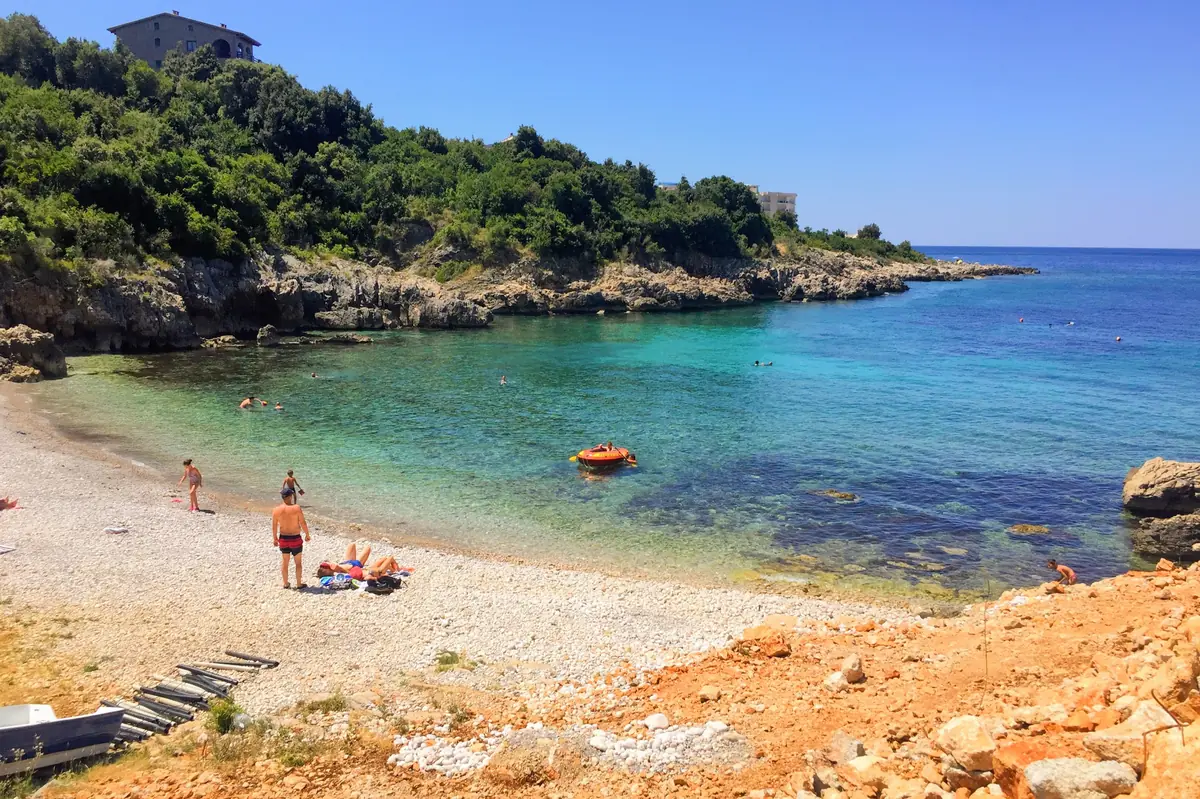 Paljuskovo Beach with Mediterranean shrubs, gin-clear awaters, and rocky shoreline