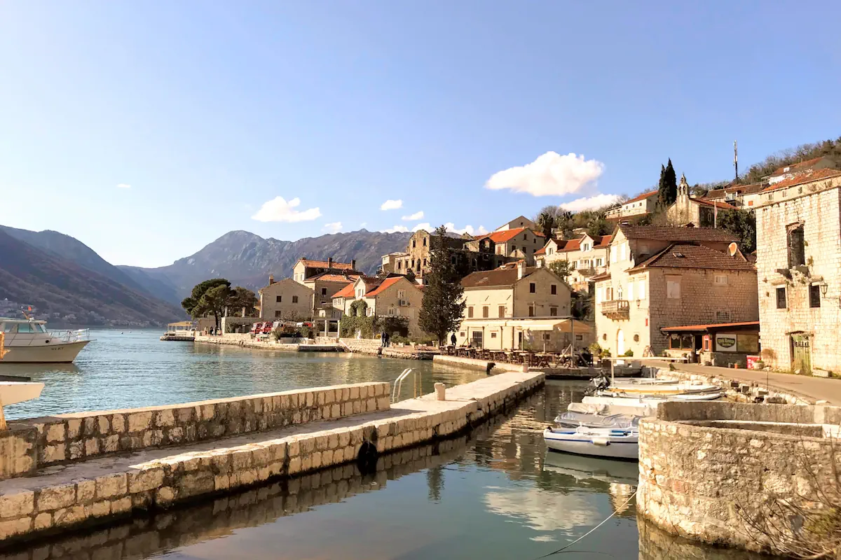 The Perast waterfront framed by stone buildings