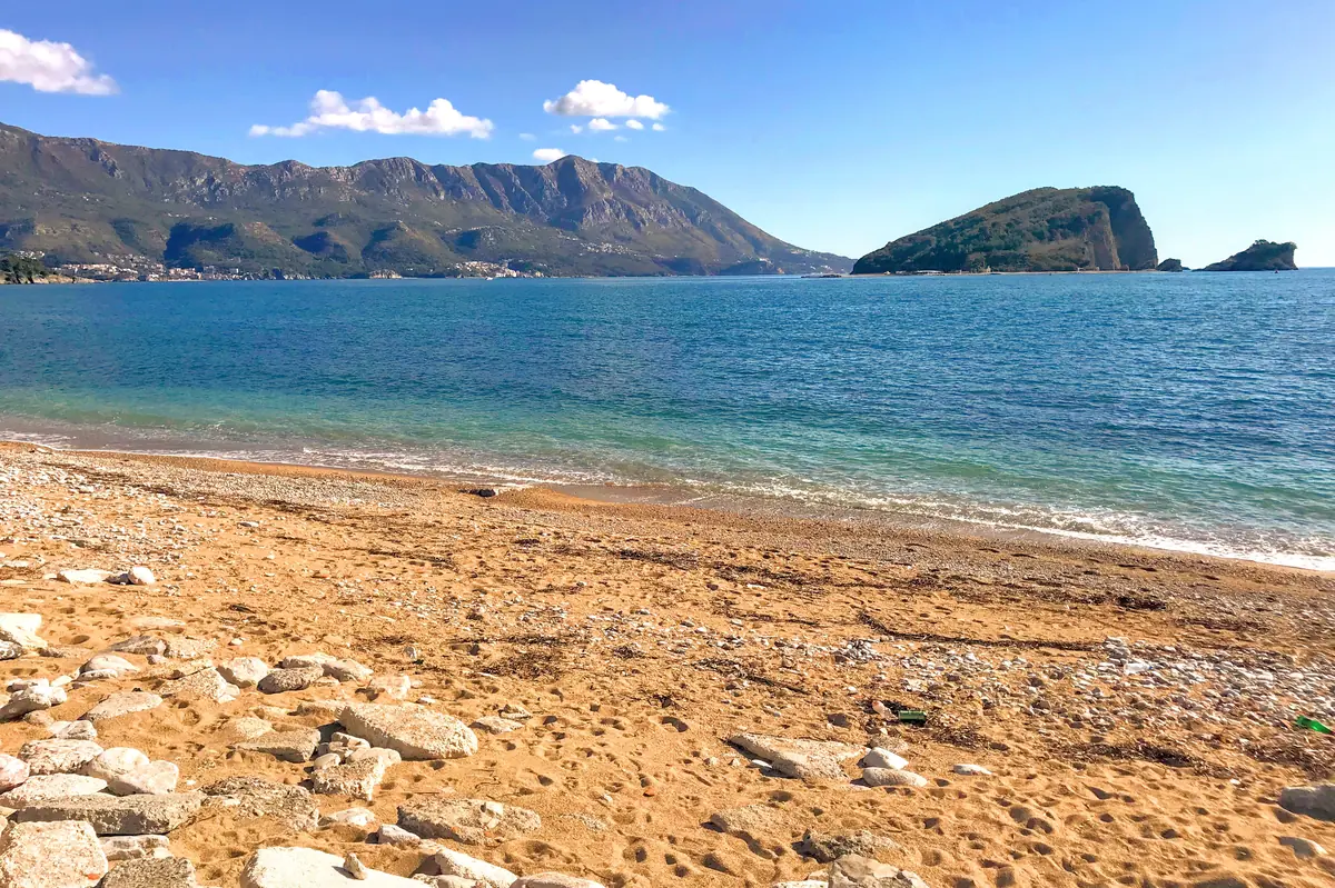 Pizana Beach in Budva, a small free cove nestled against the medieval city walls and the marina
