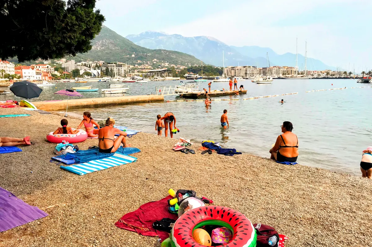 Ponta Seljanovo Beach Tivat featuring the V-shaped pebbly point overlooking Porto Montenegro