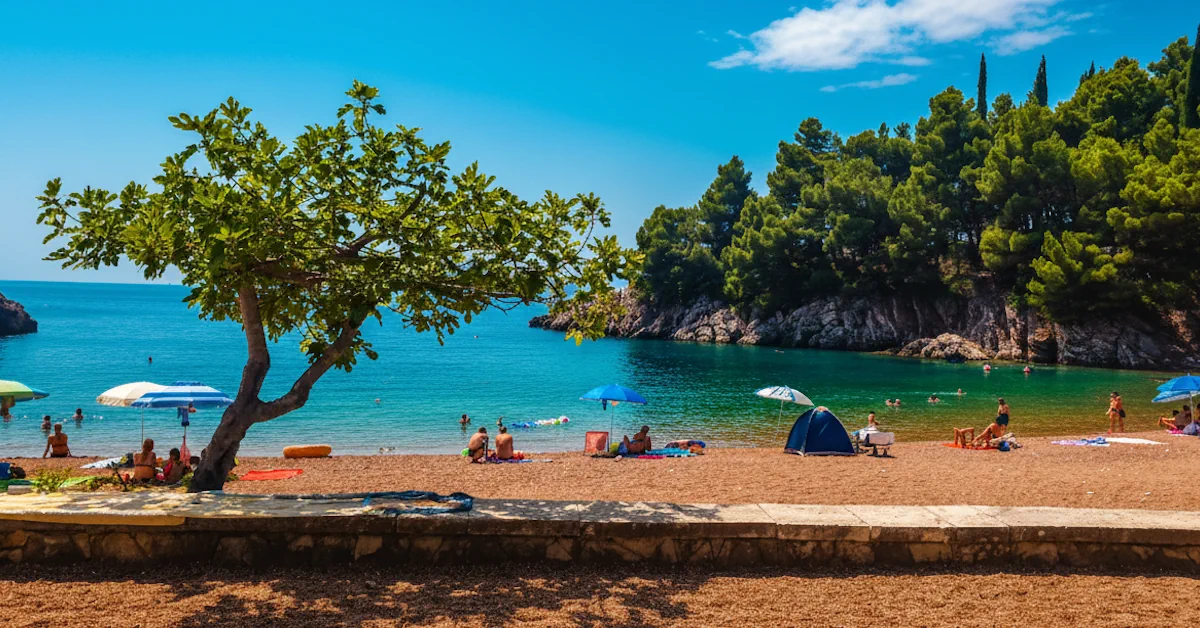 Queens Beach near Sveti Stefan, an exclusive, secluded cove with sapphire water and pine-draped cliffs