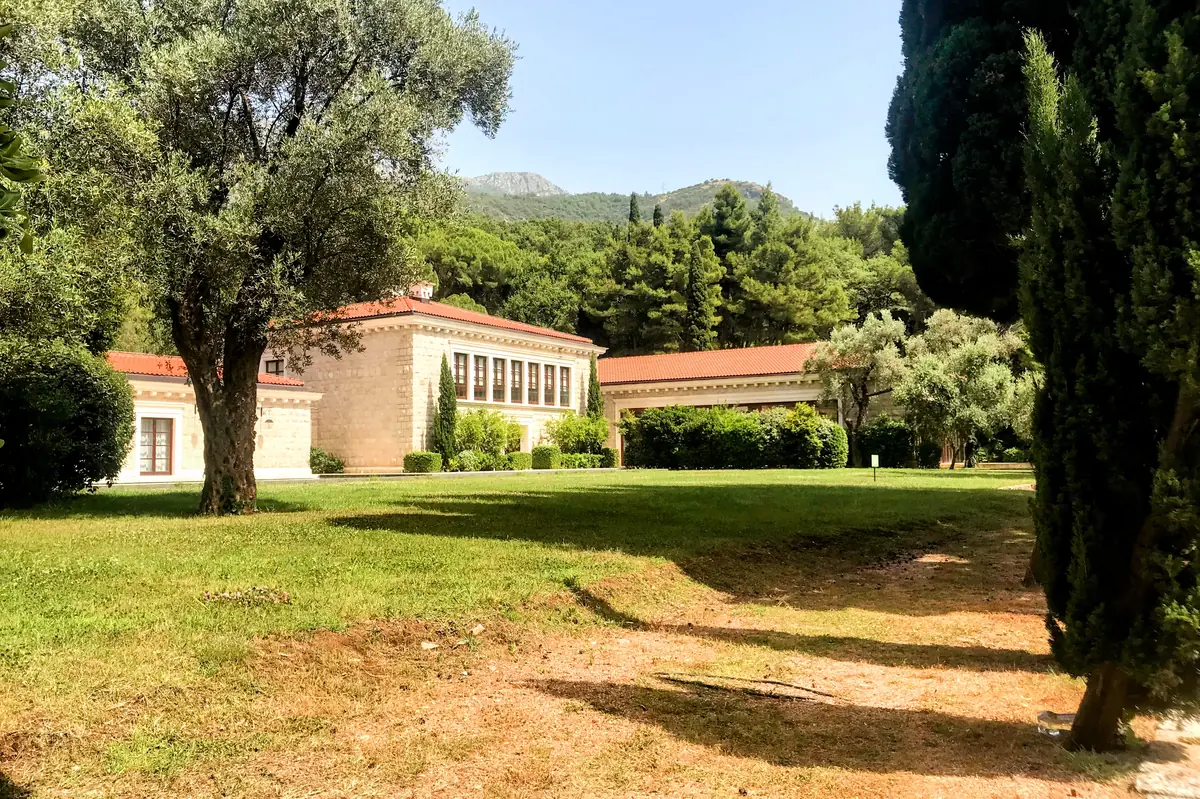 Quens Beach hotel building surrounded by lush vegetation