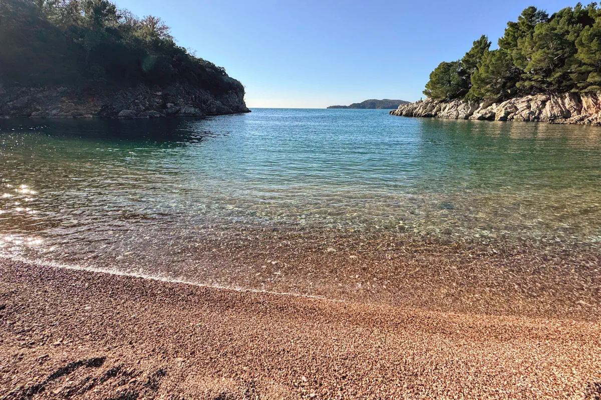 Queens Beach, near Sveti Stefan with pink pebbles and crystal-clear waters