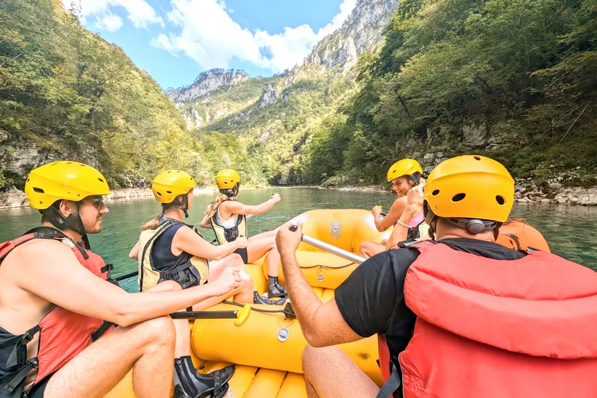 A yellow rafting boat navigating the white water rapids of the Tara River Canyon