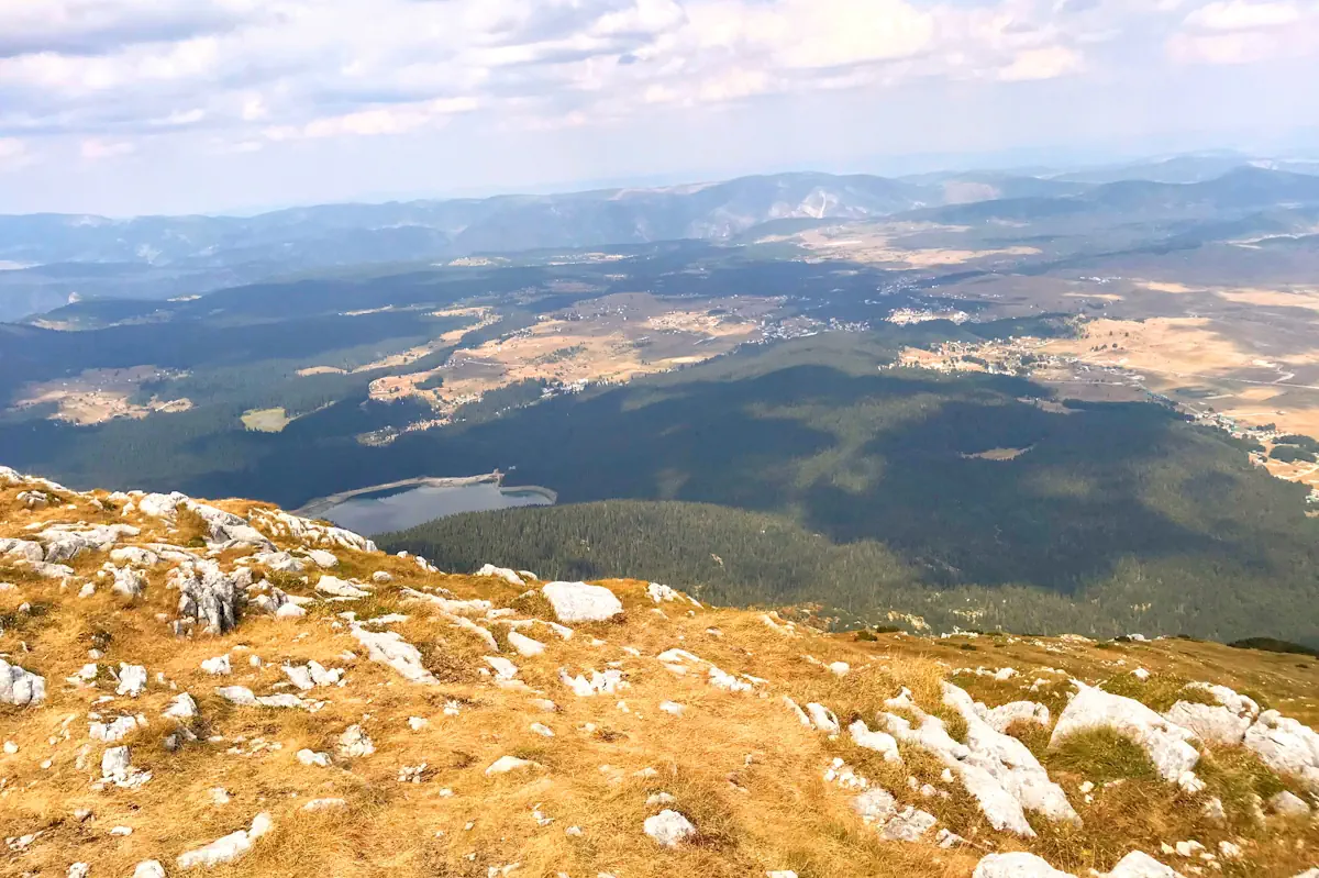 Panoramic view from Savin Kuk summit overlooking Black Lake and the rolling alpine meadows of Durmitor