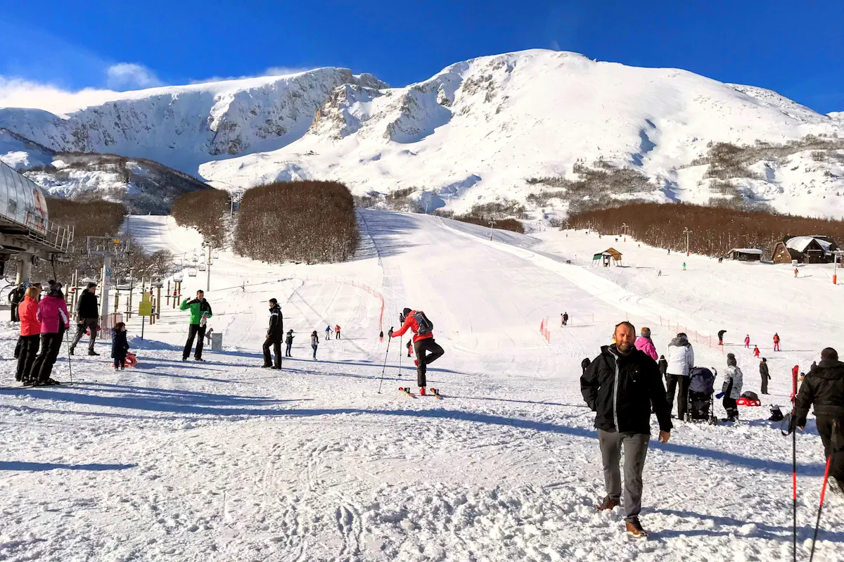 Skiers on the Savin Kuk slopes under the Durmitor peaks
