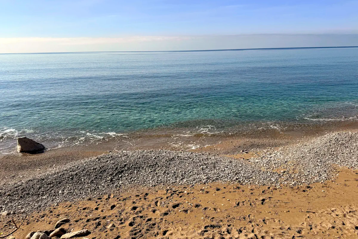 Sutomore primary beachfront pebbly shoreline and crystal-clear water