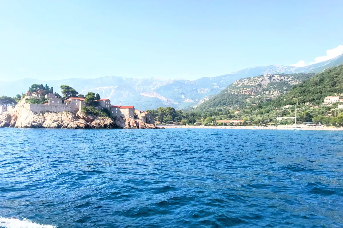 Sveti Stefan Beach and the resort island photographed from a boat