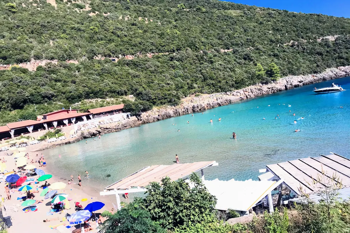 Aerial View of Trsteno Beach with its very shallow waters, parasols and beach bars