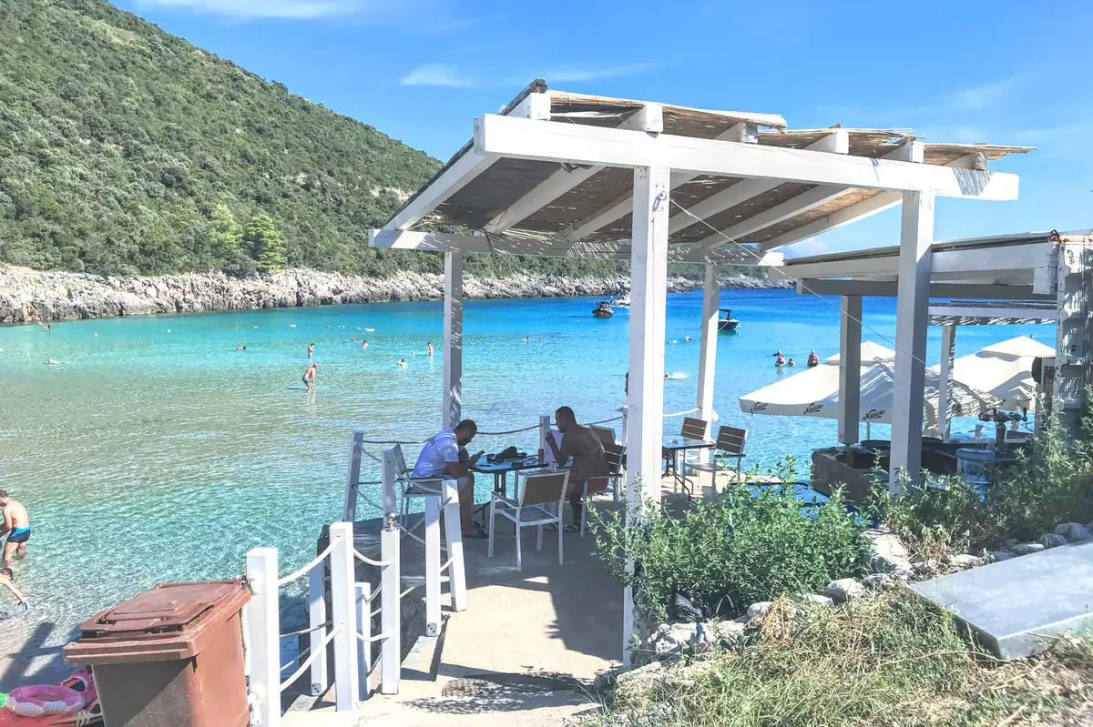 Trsteno Beach Bar hovering over the turquoise colored waters