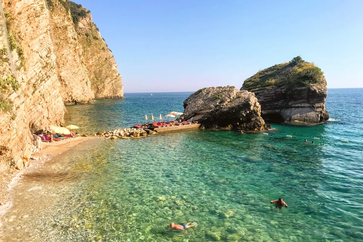 The crescent shaped shoreline of Halfmoon Beach on Sveti Nikola Island near Budva