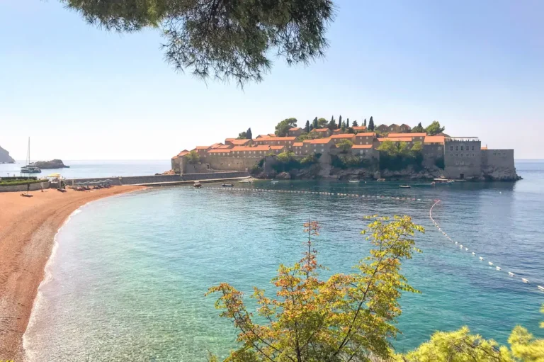 Frontal view of Sveti Stefan resort island and the nothern end of its beach, taken from the hiking trail towards Milocer Park.