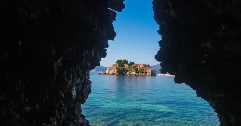 Crvena Stijena Beach near Sveti Stefan with the iconic sea arch looking out onto the resort island