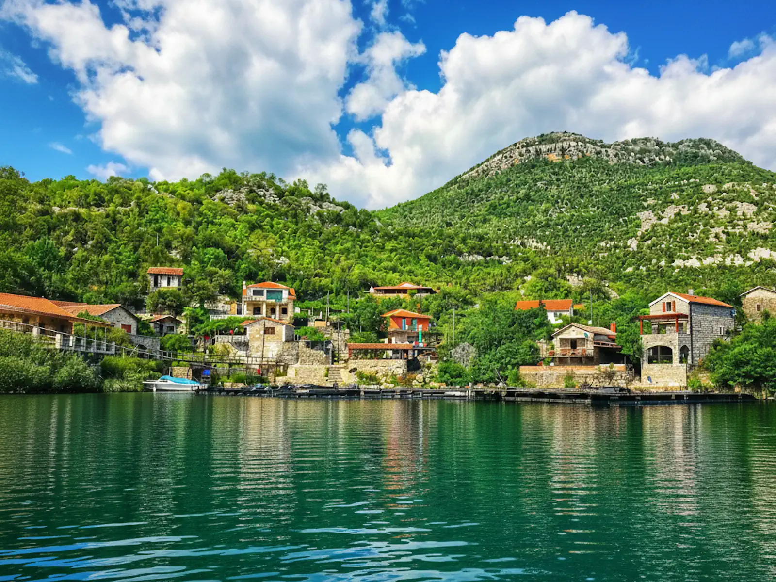 View of the terraced stone houses of Karuc, near Rijeka Crnojevica, from a boat