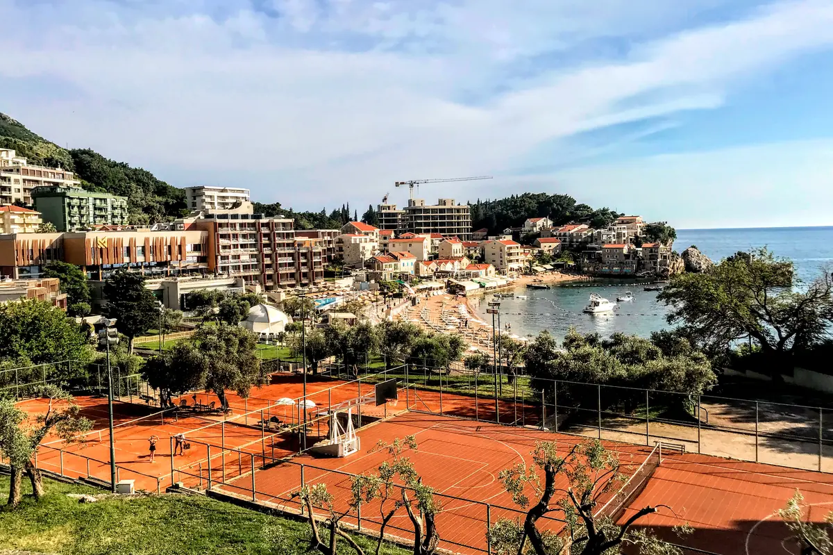 Aerial view of the fishing village and beach of Przno with Hotel Maestral's tennis court