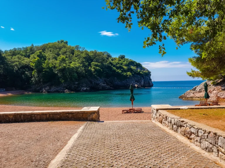 Queens Beach near Sveti Stefan, near the entrance gate, overlooking pink pebbles and comofortably spaced sun loungers