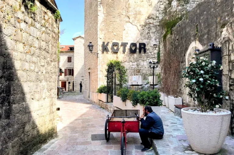Kotor Old Town alleyway & man with hand carriage