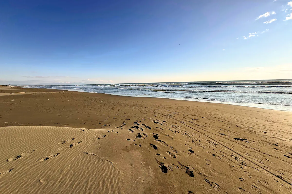 Long stretch of volcanic sand on an trianglular island South of Ulcinj, Ada Bojana Beach