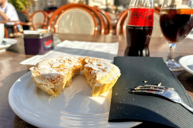 A slice of authentic Perast cake (Peraška torta), a traditional Montenegrin almond and lemon dessert from the Bay of Kotor.
