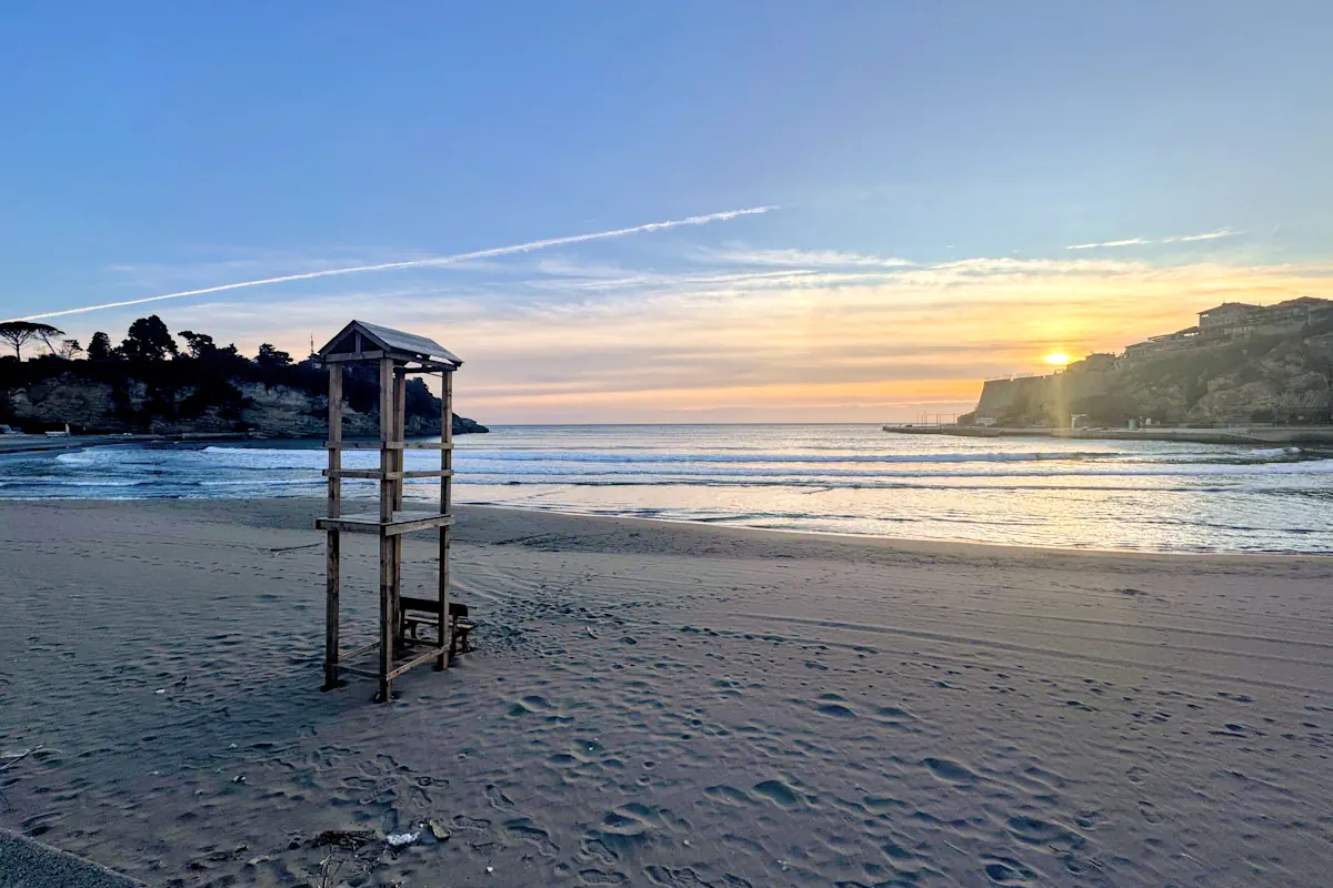 Sandy Mala Plaza Small Beach at sunset with wooden lifeguard tower.