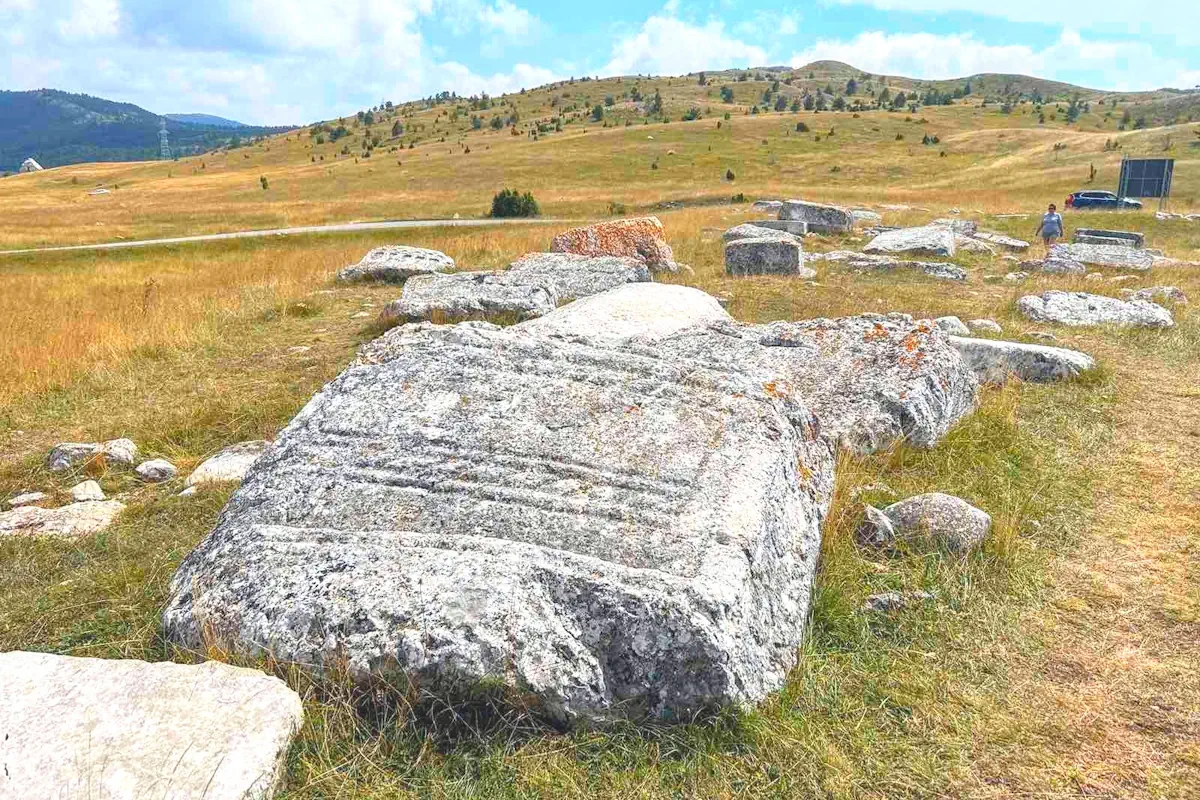 Medieval Stećci tombstones in Durmitor National Park, part of the UNESCO World Heritage list in Montenegro, mountains in the background.